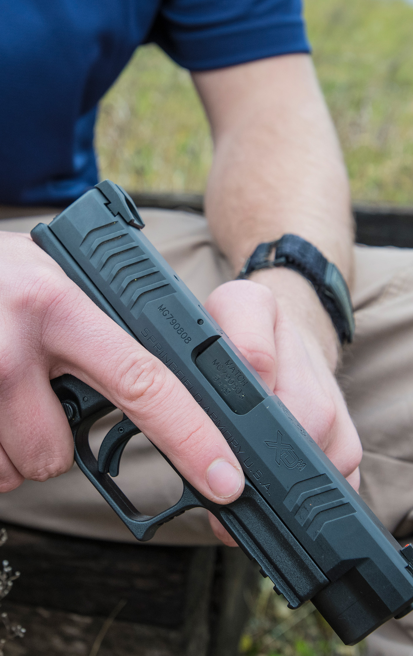 Close up of a man's hand holding a pistol.