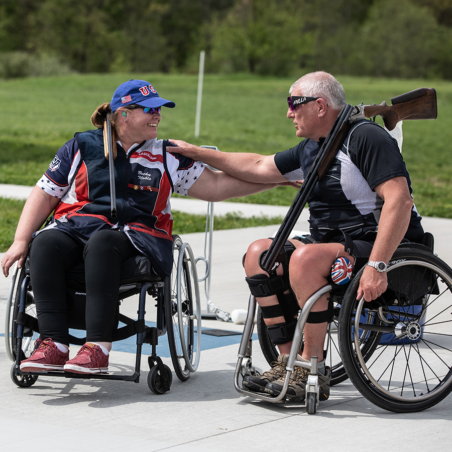 Two people in wheel chairs embracing
