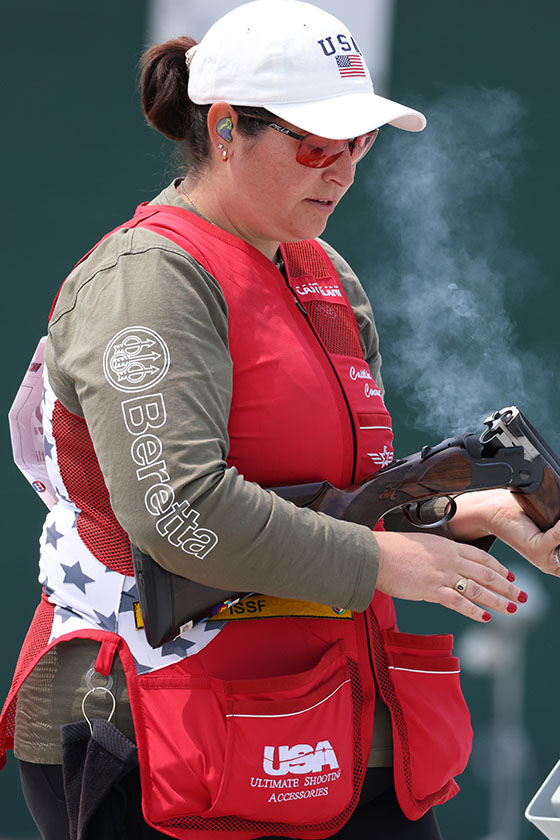 A female instructor in a red vest.